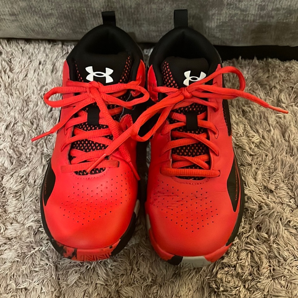 Red and black Under Armour boy basketball shoes